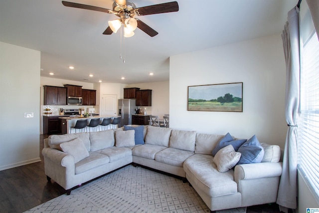 living room with dark hardwood / wood-style floors and ceiling fan