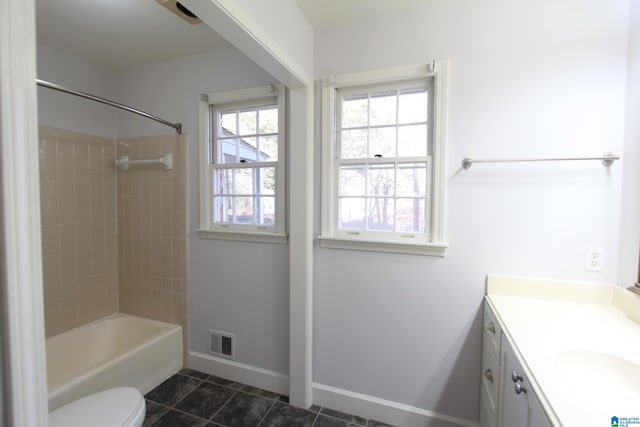 full bathroom with toilet, vanity, tile patterned floors, and tiled shower / bath