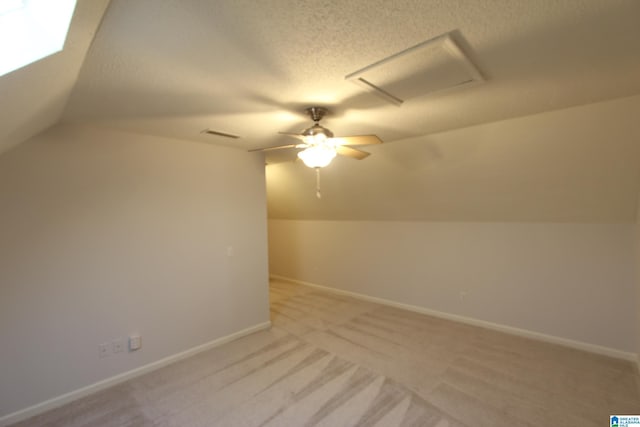 bonus room with ceiling fan, light colored carpet, a textured ceiling, and lofted ceiling