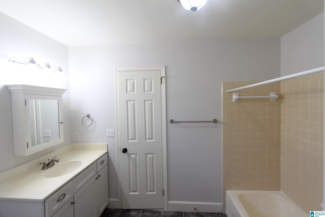 bathroom with tiled shower / bath and vanity