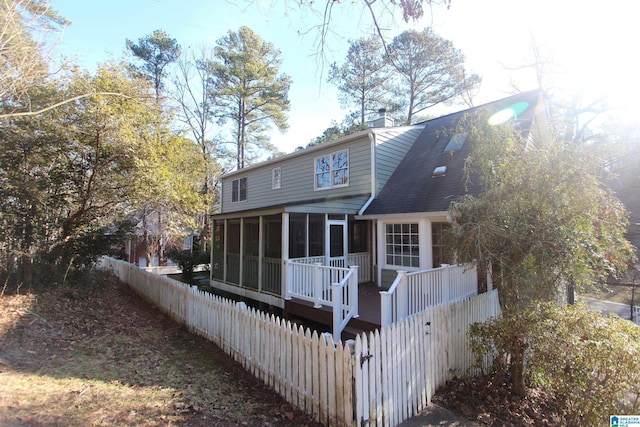 rear view of house with a sunroom