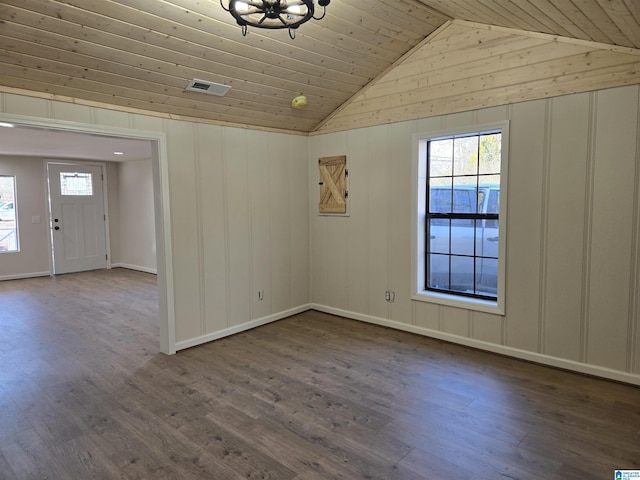 empty room featuring wooden ceiling, vaulted ceiling, a notable chandelier, and hardwood / wood-style floors