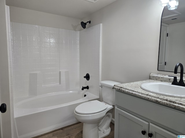 full bathroom featuring tub / shower combination, vanity, wood-type flooring, and toilet