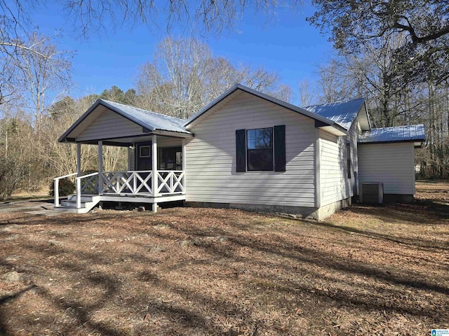 view of front of home with cooling unit and a porch