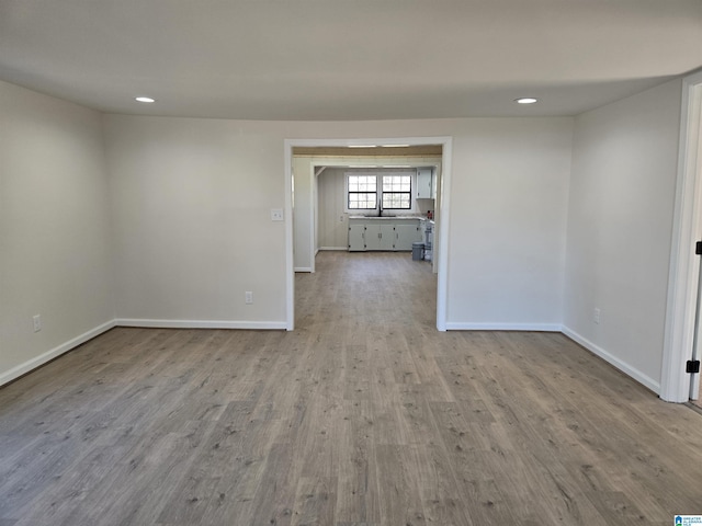 spare room with sink and light hardwood / wood-style flooring