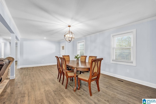 dining space featuring crown molding, plenty of natural light, and an inviting chandelier