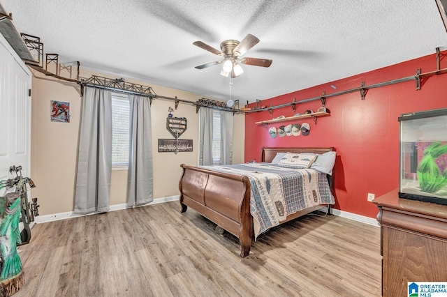 bedroom featuring ceiling fan, a textured ceiling, and hardwood / wood-style flooring