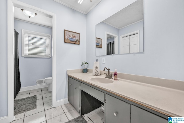 bathroom with toilet, ornamental molding, tile patterned flooring, and vanity