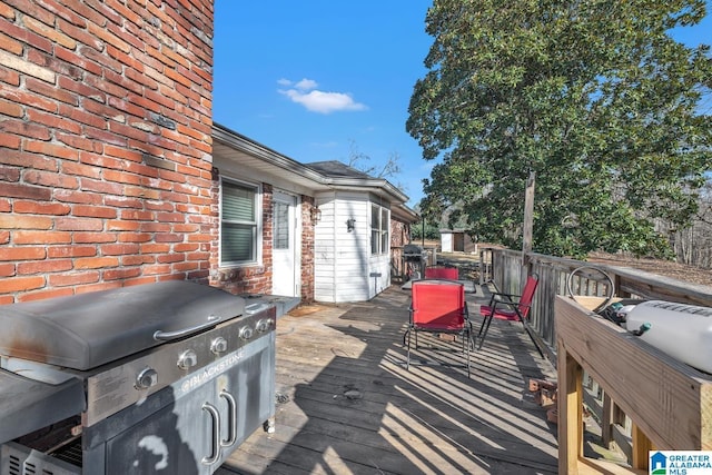 wooden deck featuring a grill