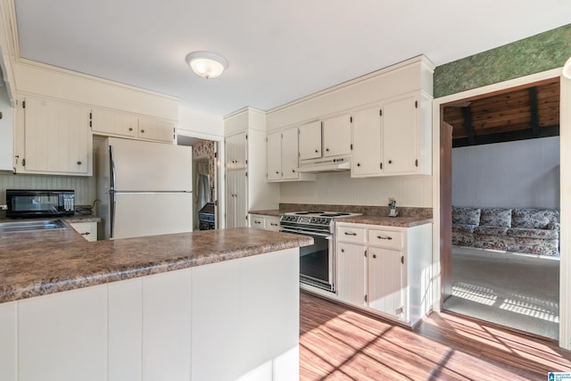 kitchen featuring sink, white cabinetry, light hardwood / wood-style flooring, range with electric cooktop, and white refrigerator