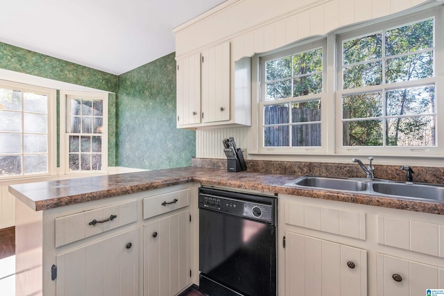 kitchen featuring kitchen peninsula, black dishwasher, white cabinets, and sink