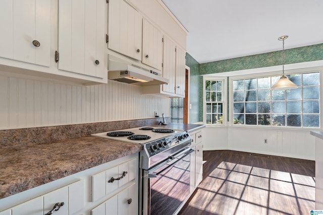 kitchen featuring stainless steel electric range, dark wood-type flooring, white cabinetry, and pendant lighting