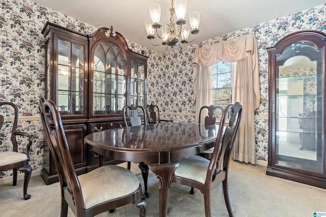 carpeted dining area featuring a chandelier