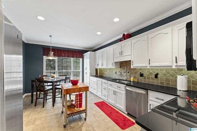 kitchen featuring appliances with stainless steel finishes, sink, white cabinets, hanging light fixtures, and ornamental molding