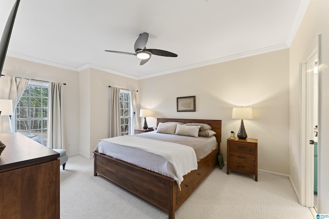 carpeted bedroom with ornamental molding and ceiling fan