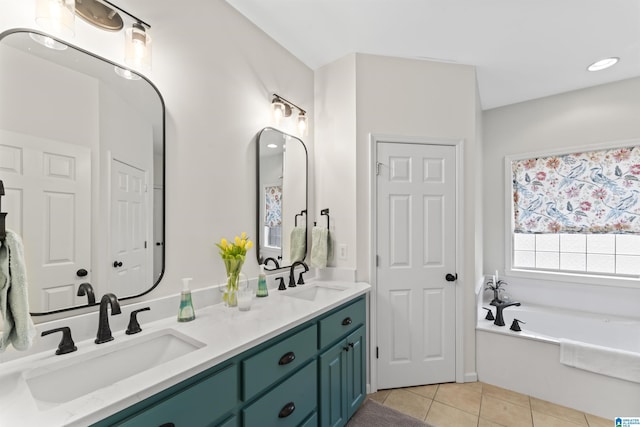 bathroom with vanity, a bathing tub, and tile patterned floors