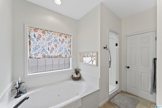 bathroom with tile patterned floors and shower with separate bathtub