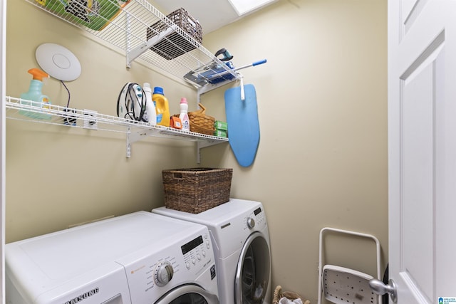 clothes washing area featuring washer and clothes dryer