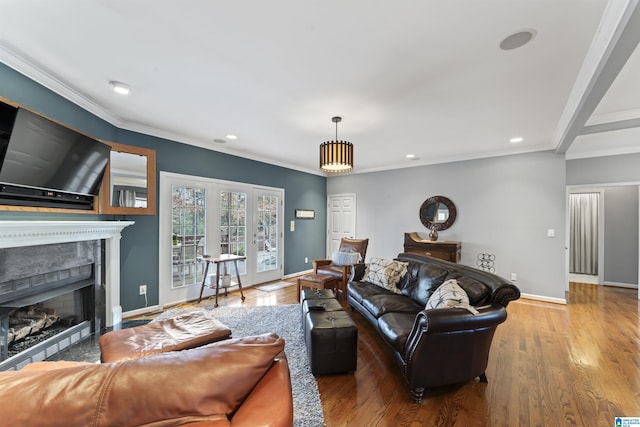 living room featuring hardwood / wood-style flooring and ornamental molding