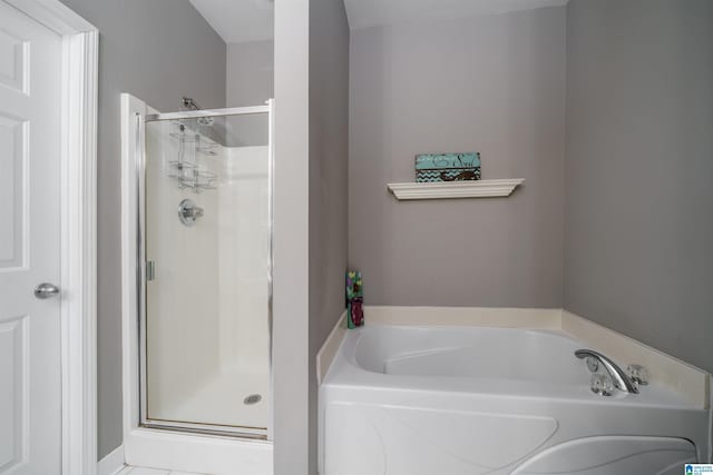 bathroom featuring separate shower and tub