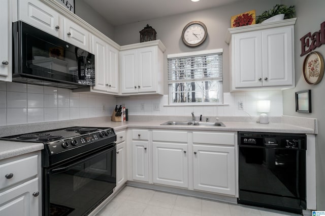 kitchen featuring sink, white cabinetry, backsplash, and black appliances