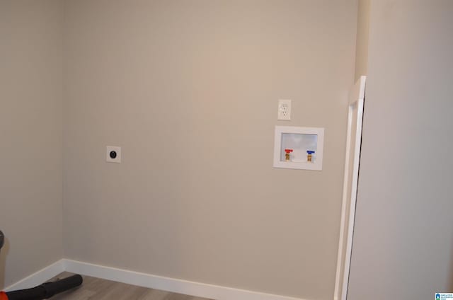 washroom with washer hookup, light hardwood / wood-style floors, and electric dryer hookup