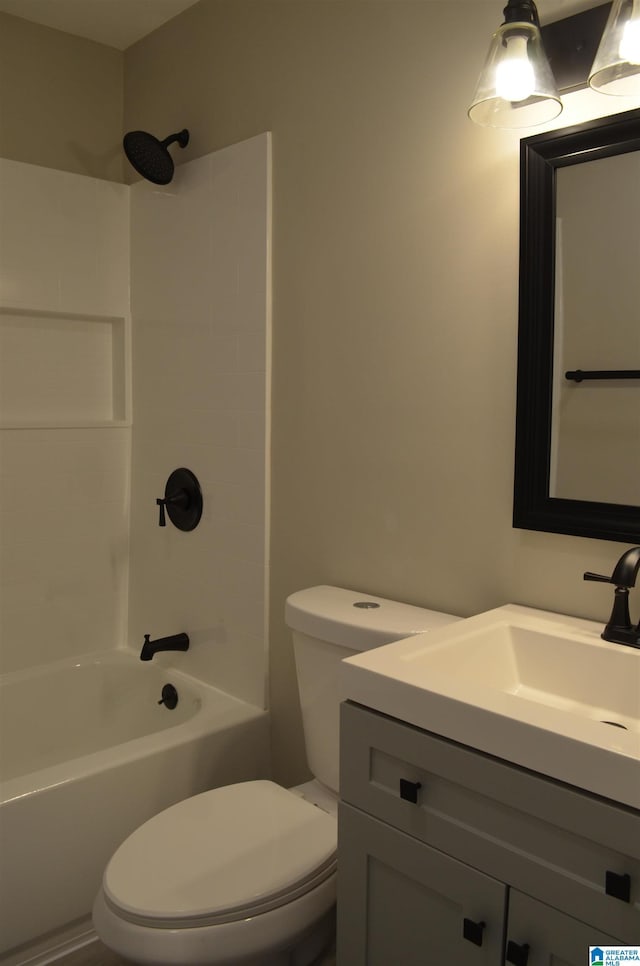 full bathroom featuring vanity, bathtub / shower combination, and toilet