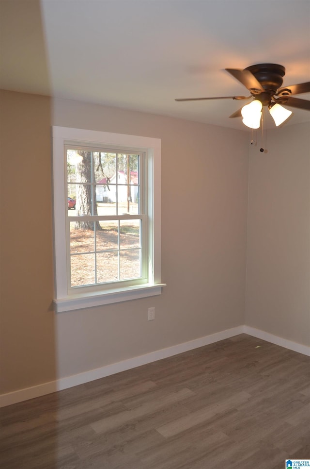 unfurnished room featuring ceiling fan and dark hardwood / wood-style flooring