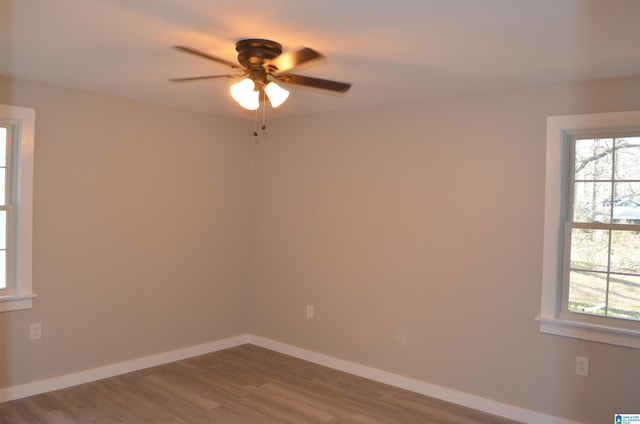 unfurnished room featuring ceiling fan and hardwood / wood-style floors