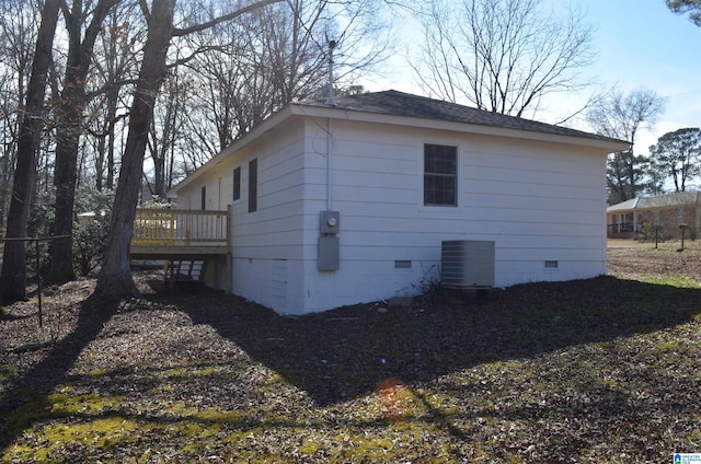 view of home's exterior with a wooden deck and central AC