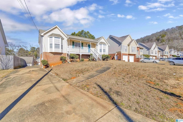 view of front of house with a front lawn, a garage, and a porch