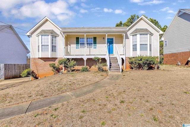 single story home featuring a front yard and covered porch