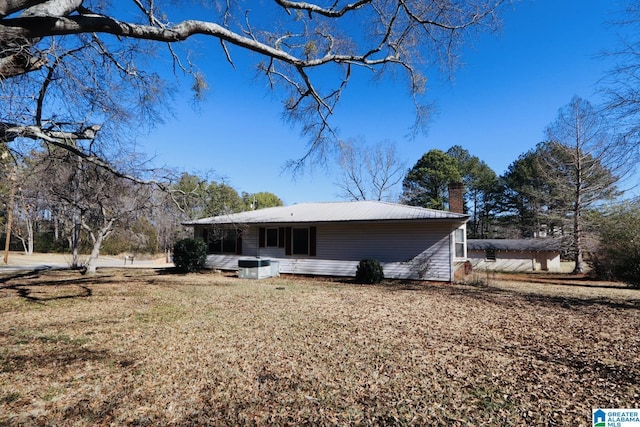 rear view of house featuring a lawn