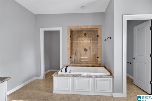 bathroom featuring tile patterned floors and separate shower and tub