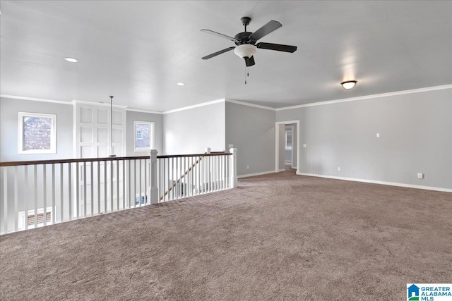 carpeted empty room with ceiling fan and ornamental molding