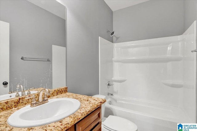 full bathroom featuring vanity, bathing tub / shower combination, and toilet