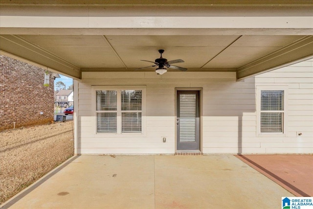 doorway to property with ceiling fan and a patio