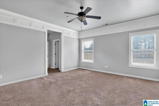 unfurnished room with ceiling fan, ornamental molding, and carpet floors