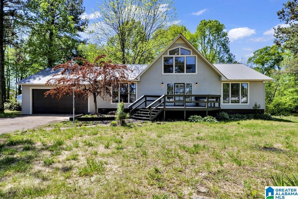 view of front of home featuring a deck and a front lawn