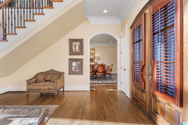 interior space featuring wood-type flooring and ornamental molding