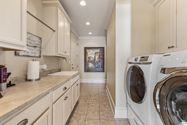 laundry room featuring washing machine and dryer, cabinets, sink, ornamental molding, and light tile patterned floors