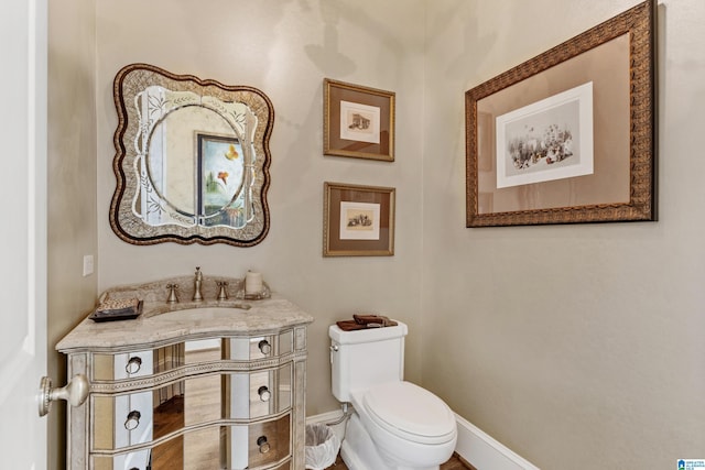 bathroom with toilet and vanity