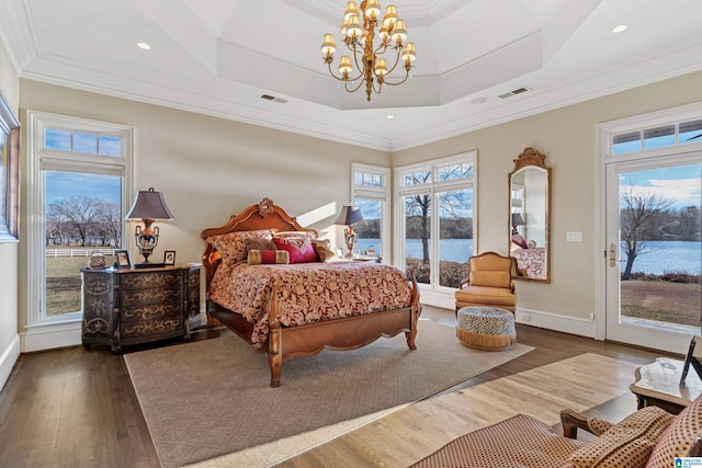 bedroom with a raised ceiling, dark wood-type flooring, access to exterior, a chandelier, and crown molding