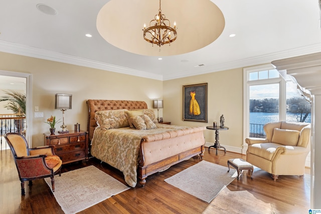 bedroom featuring access to outside, wood-type flooring, crown molding, an inviting chandelier, and a water view