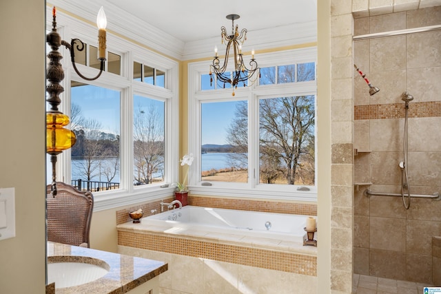 bathroom with vanity, a notable chandelier, tiled tub, ornamental molding, and a water view