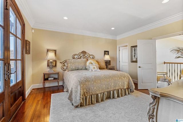 bedroom featuring hardwood / wood-style flooring, multiple windows, and crown molding