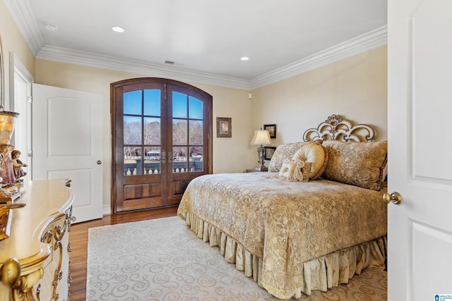 bedroom with access to exterior, light hardwood / wood-style flooring, ornamental molding, and french doors