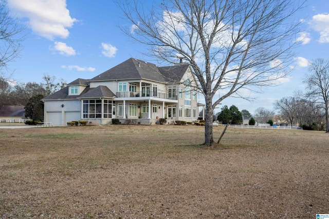 victorian house with a front yard, a garage, and a sunroom