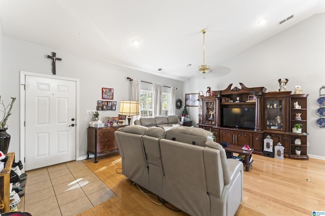 living room with vaulted ceiling and light hardwood / wood-style flooring