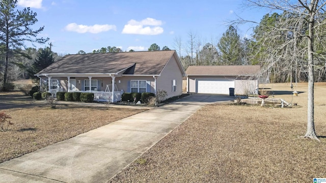 ranch-style home featuring covered porch, a garage, and an outbuilding